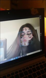 a woman is holding a laptop and a picture of a cat