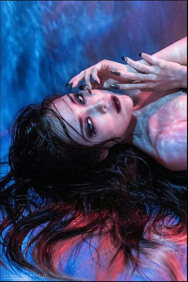 a woman is laying on a bed with a man