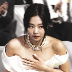 Woman in white dress and pearl necklace