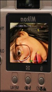 a person holding a camera and a tv