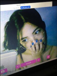 A screenshot of a computer screen displays a young woman with dark hair and blue nail polish, wearing glasses and holding her hand to her face. The screen shows a Google Ads window with the message "Stop seeing this ad." The lower portion of the screen displays navigation buttons, including "Normal."