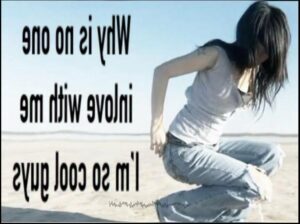 a woman is sitting on a beach with a surfboard