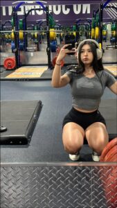 a woman in a bikini sitting on a bench