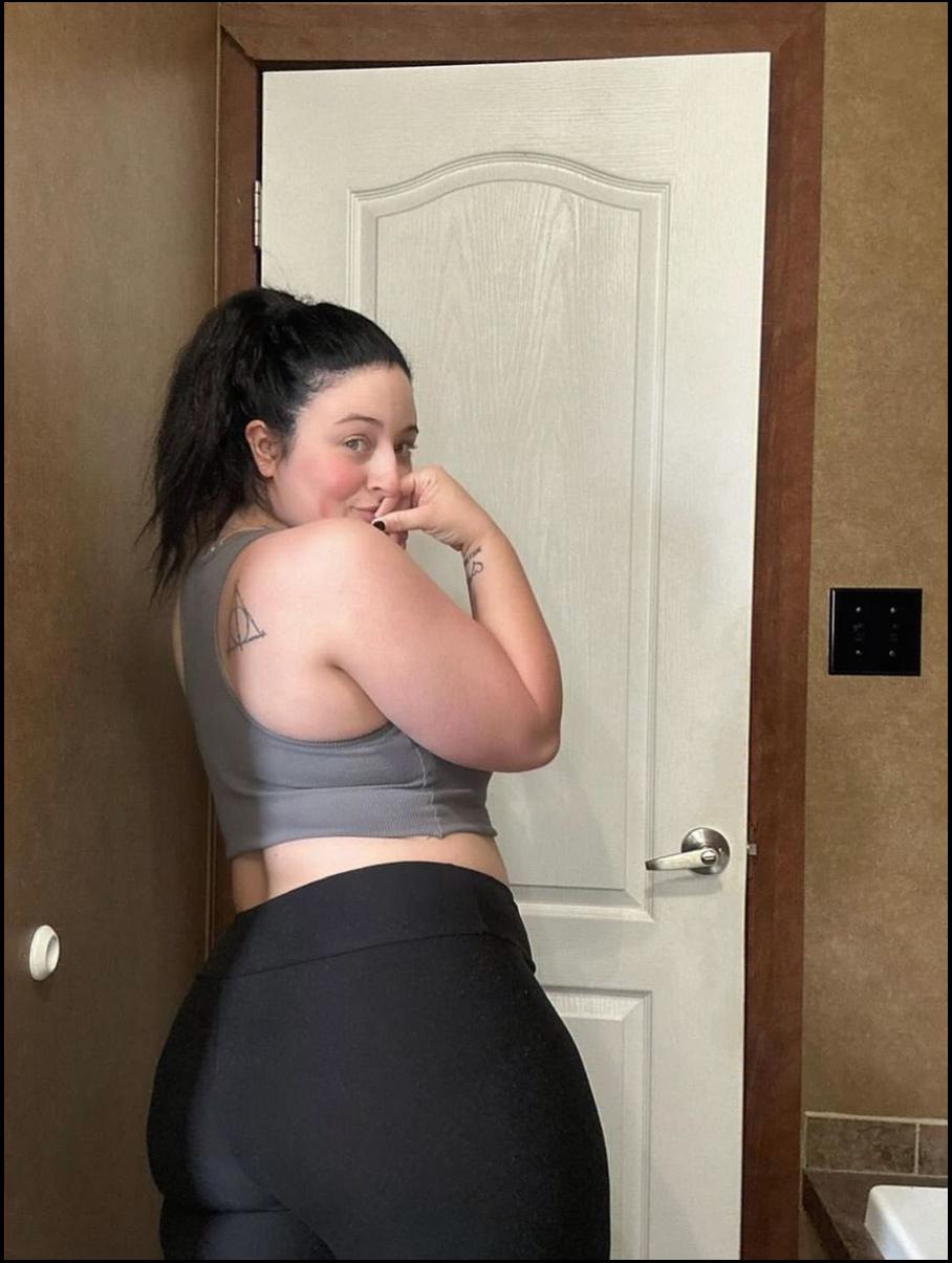 a woman is standing in front of a door