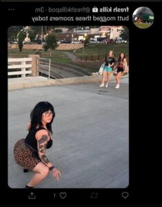 a woman is standing on a sidewalk with a skateboard