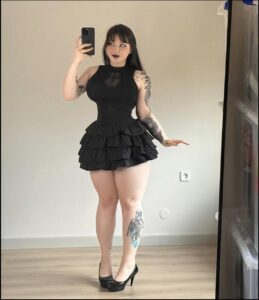 a woman is standing in a room with a camera