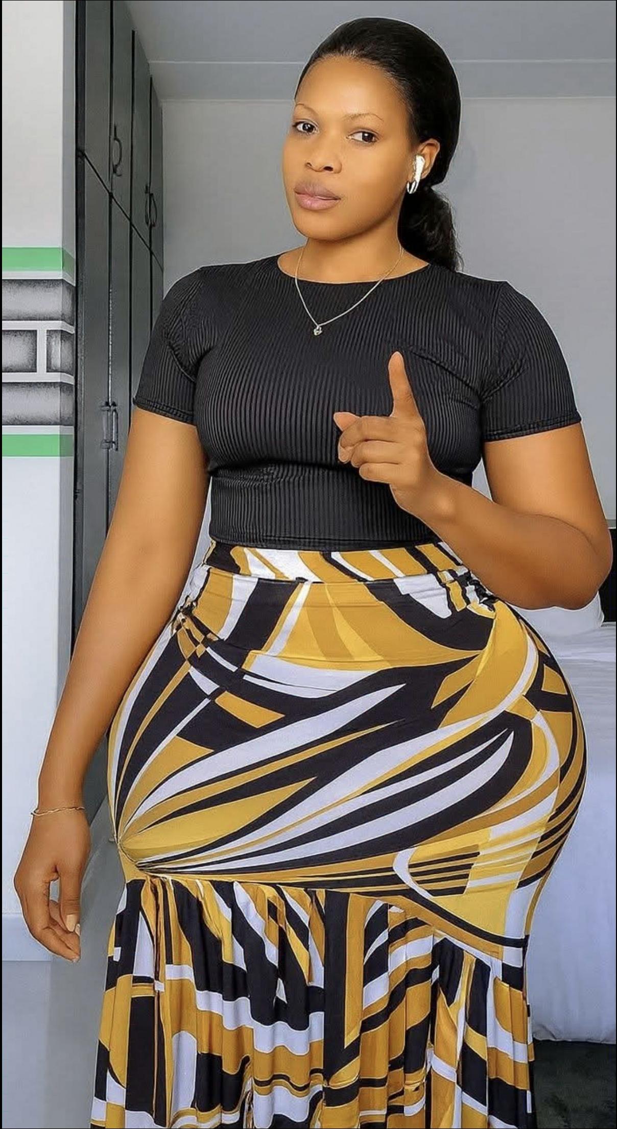 a woman is posing for a picture in a room