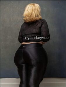 a woman in a black dress and black boots