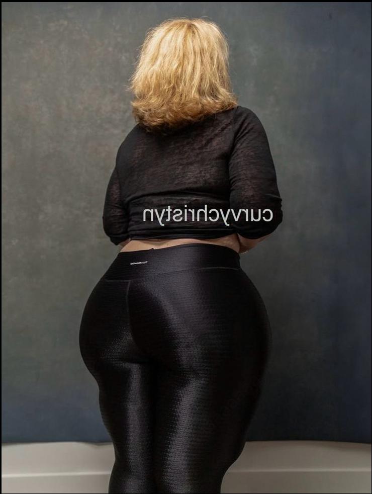 a woman in a black dress and black boots