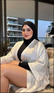 a woman sitting on a bench in front of a building