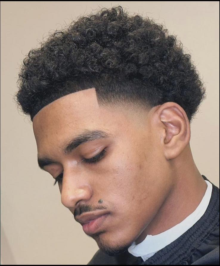 a man with a black shirt and a black tie