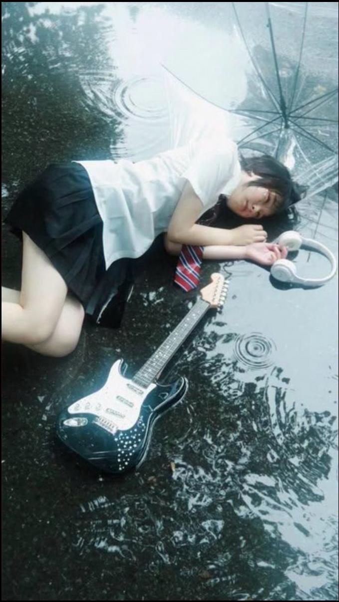 a person laying on the ground with an umbrella