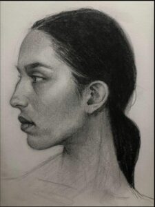 a man with a beard is standing in front of a painting