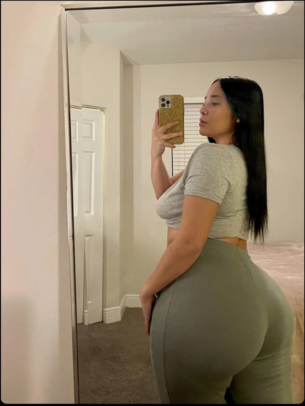 a woman is holding a cup and a bottle