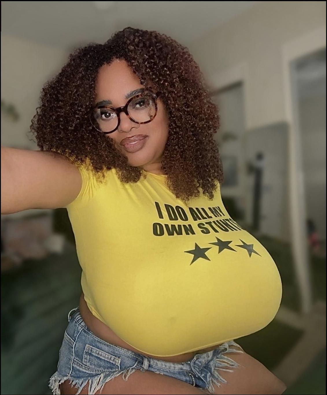 a woman wearing a pink shirt and a yellow tie