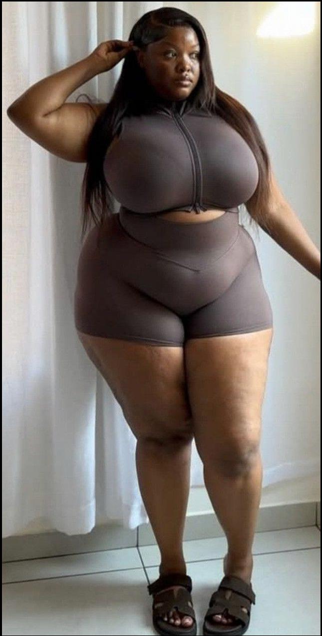 a woman in a black dress is holding a black pole