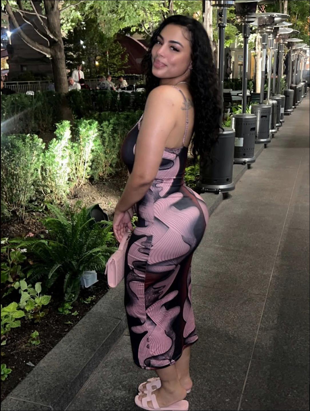 a woman in a black dress and a black hat