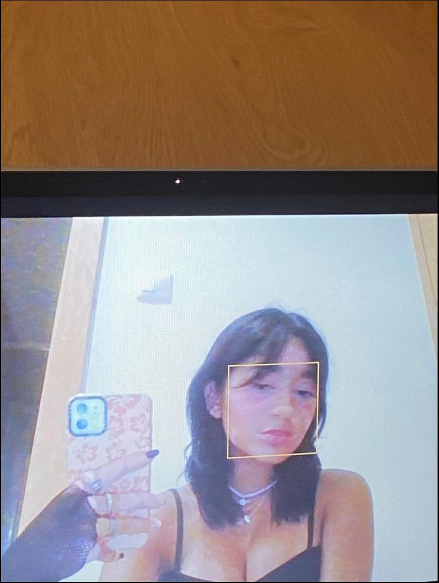 a woman is holding a cell phone and a picture