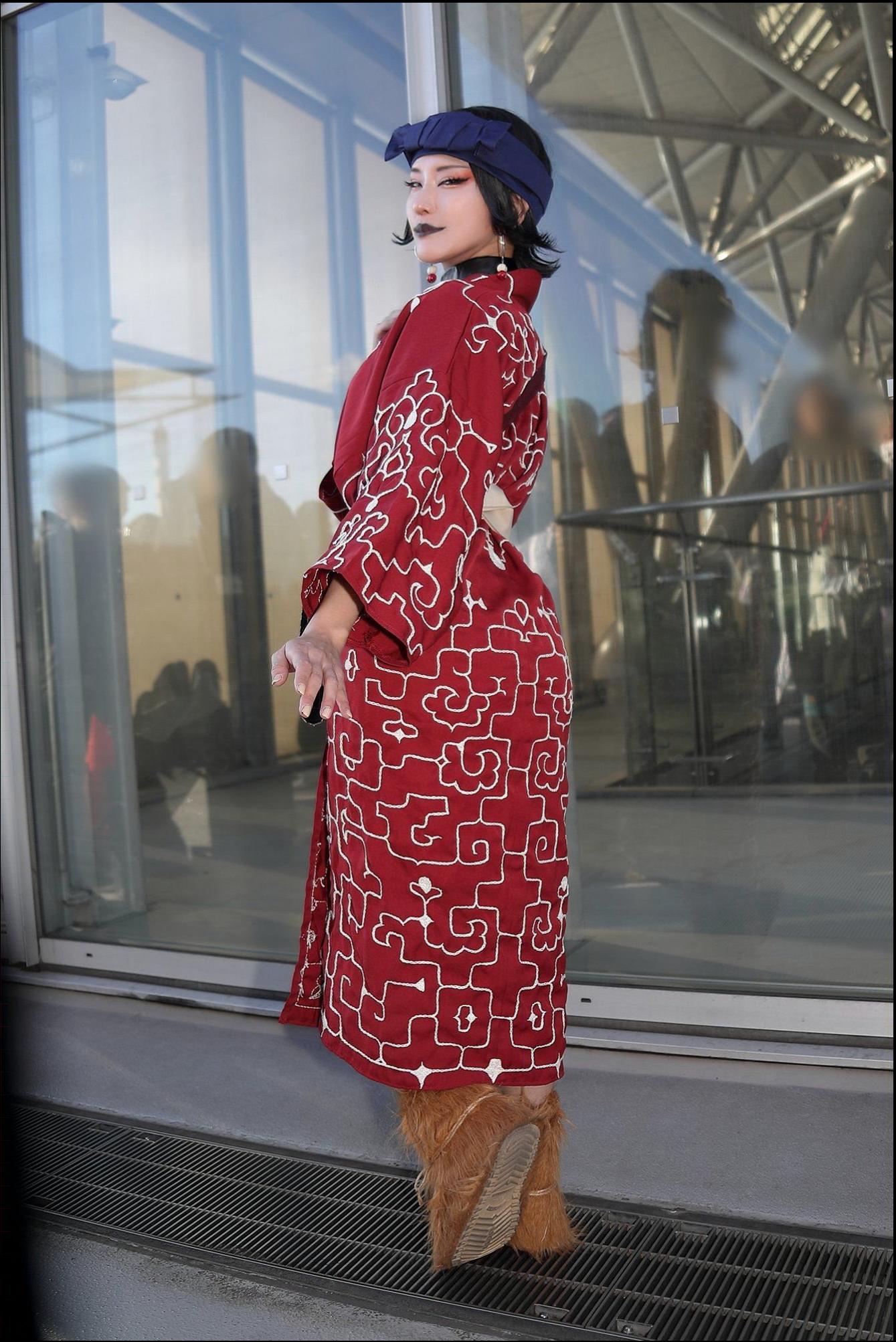 a woman dressed in a red dress and holding a red umbrella