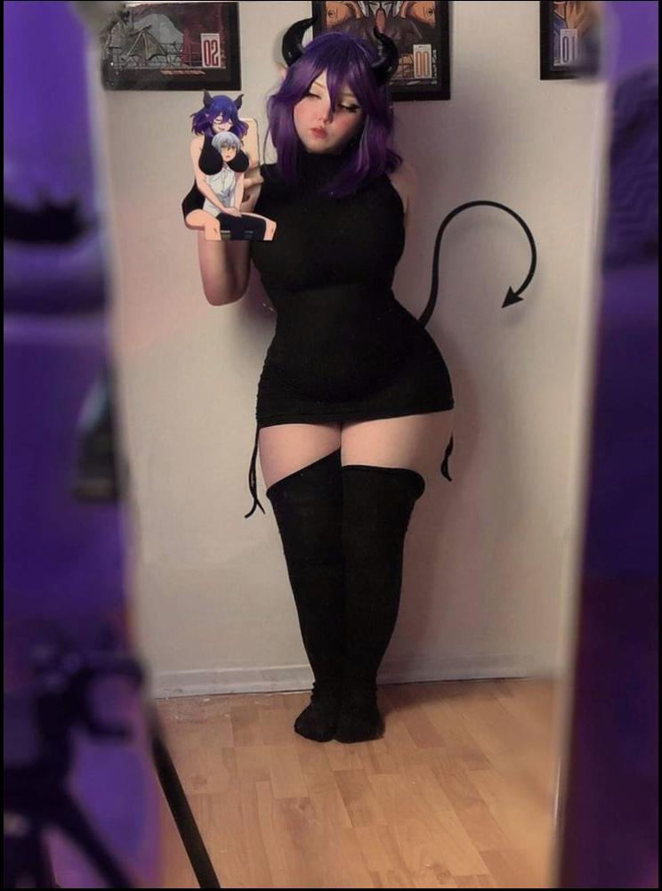 a woman in a black dress is holding a camera