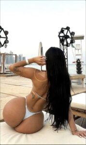 a woman is on a beach with a surfboard