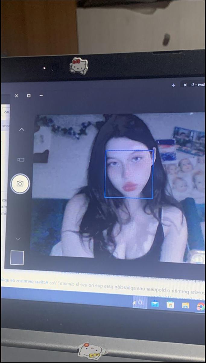 a woman is sitting in front of a tv with a laptop