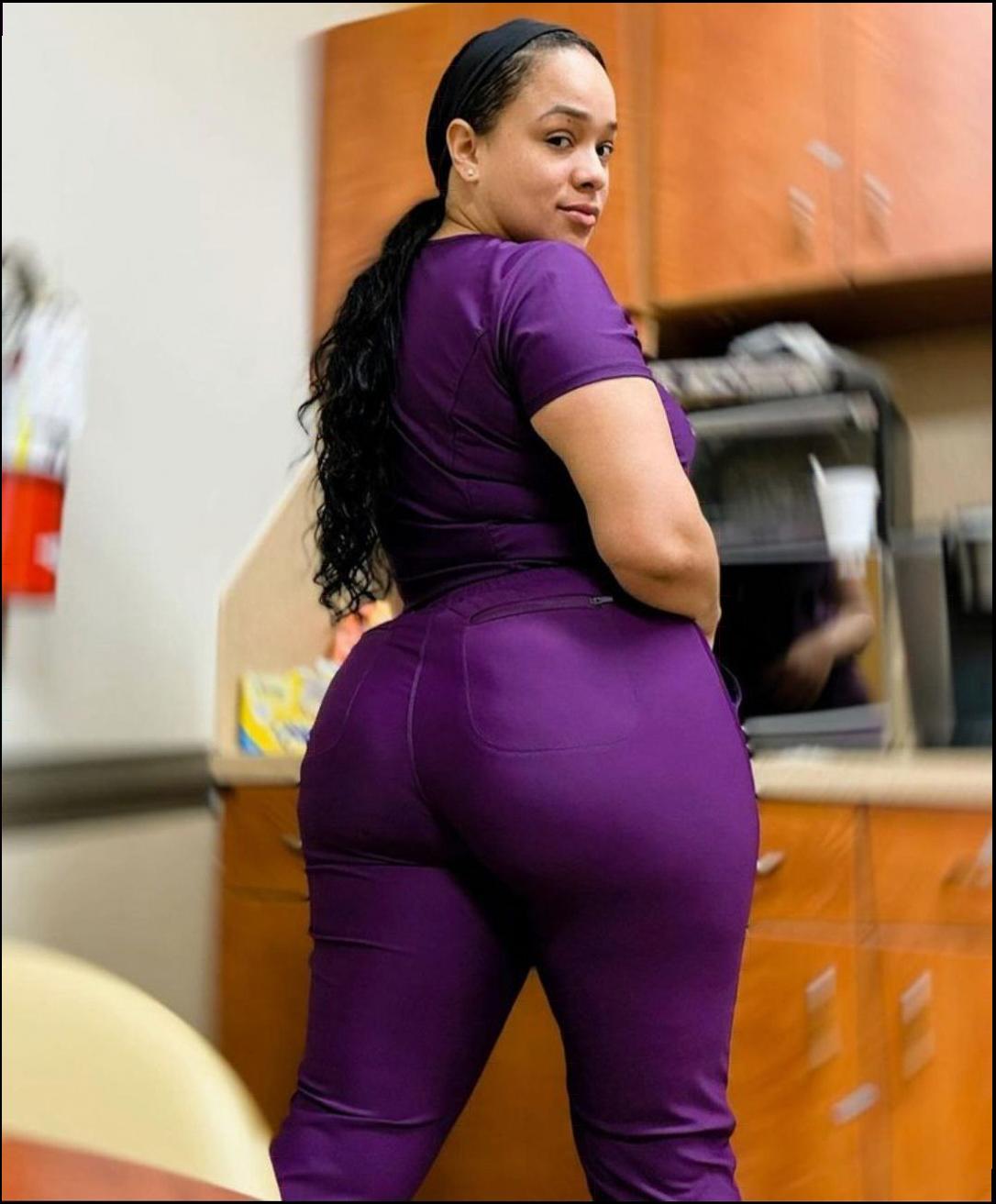 a woman in a pink dress standing in a kitchen