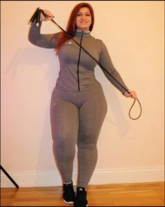 a woman in a black dress is playing a video game