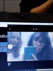 a woman is looking at a laptop on a tv