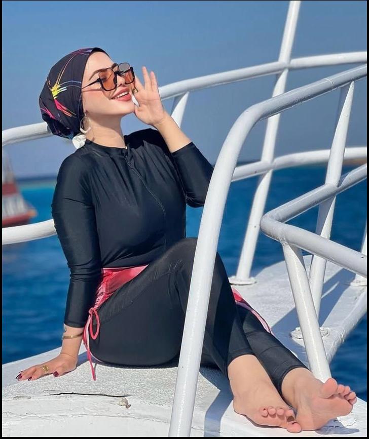 a man sitting on a bench eating a sandwich