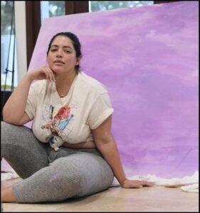 a woman sitting on a bench with a picture of a man