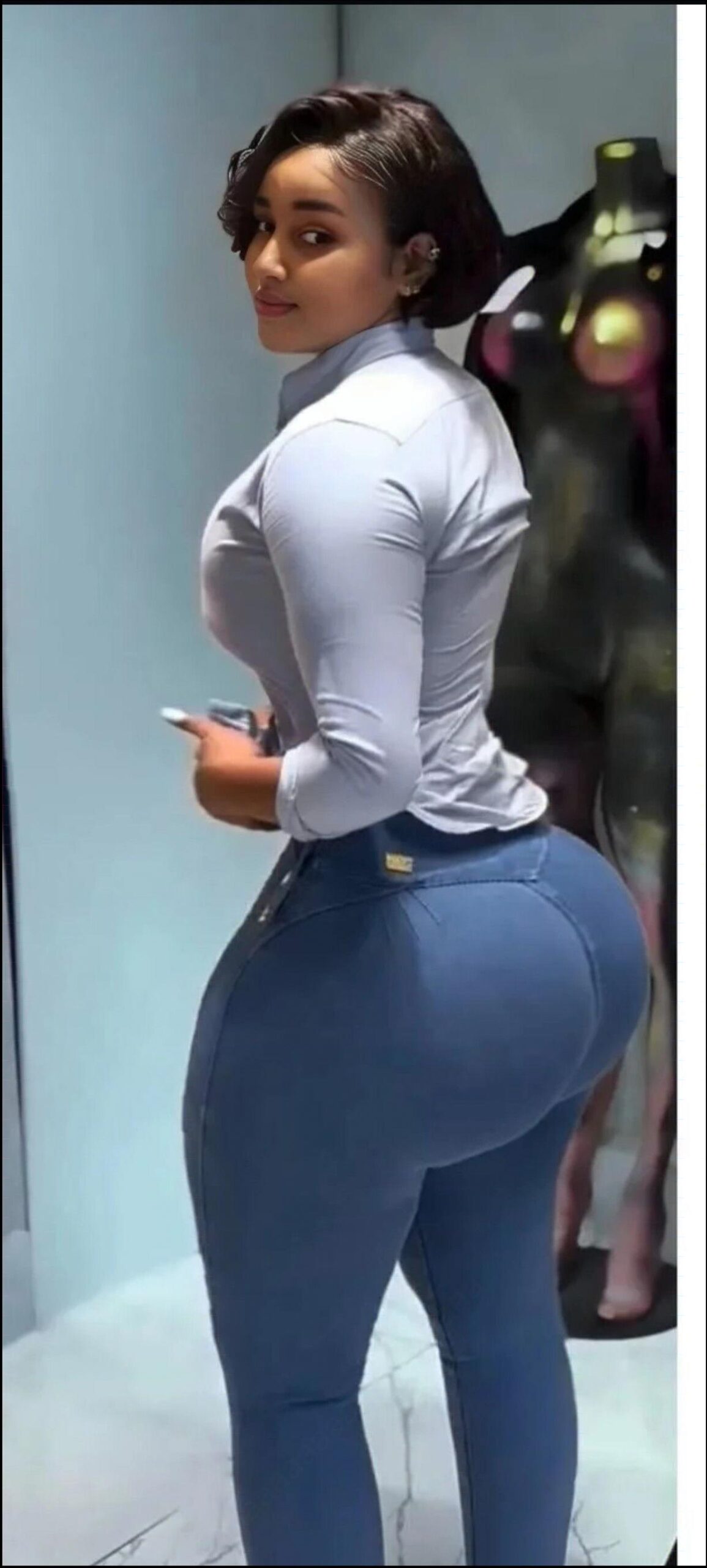 a woman in a blue dress is standing on a stage