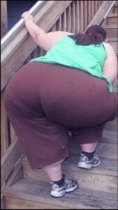 a woman is laying on a bench