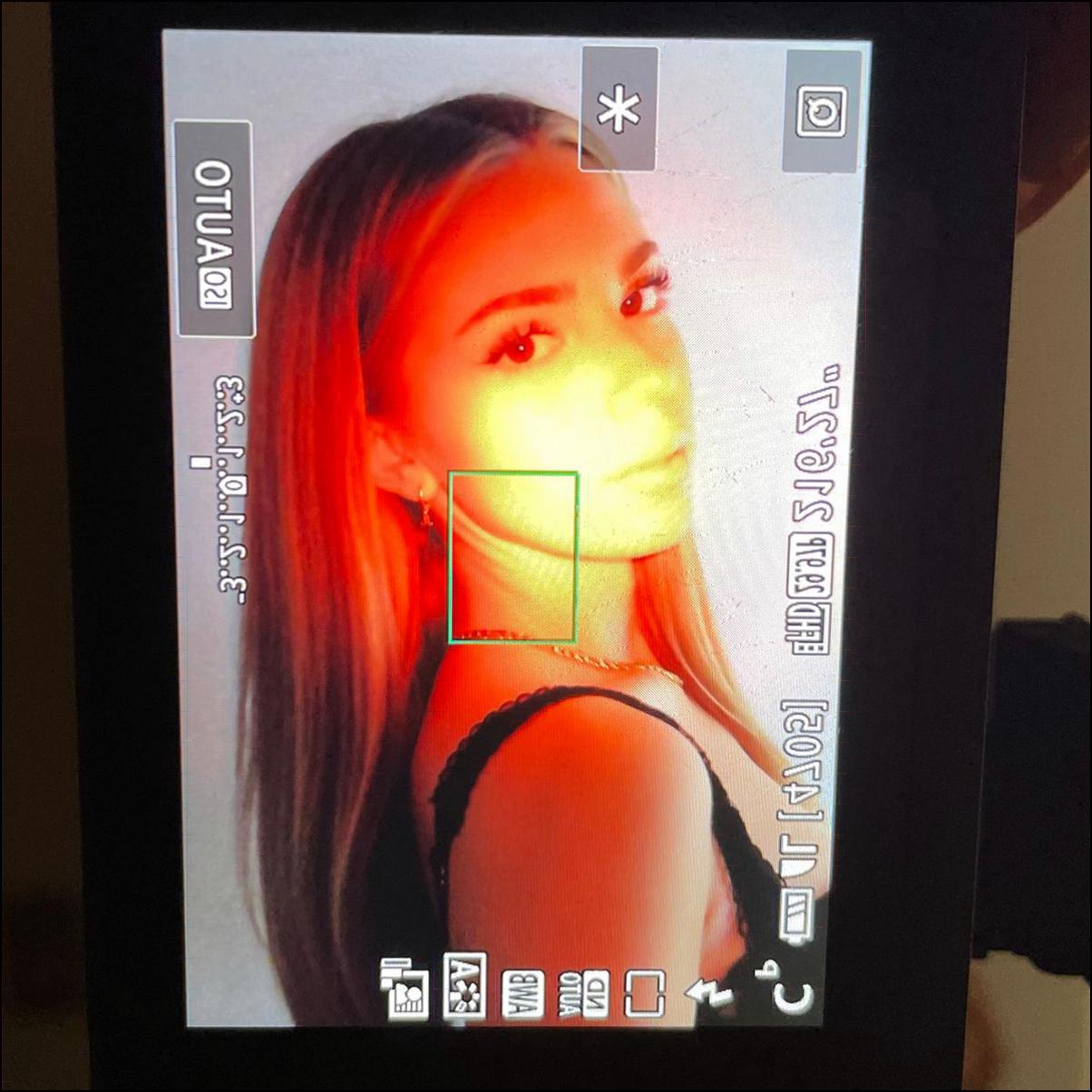 a woman with a red face on a tv