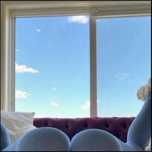 a bed with a white blanket and a window