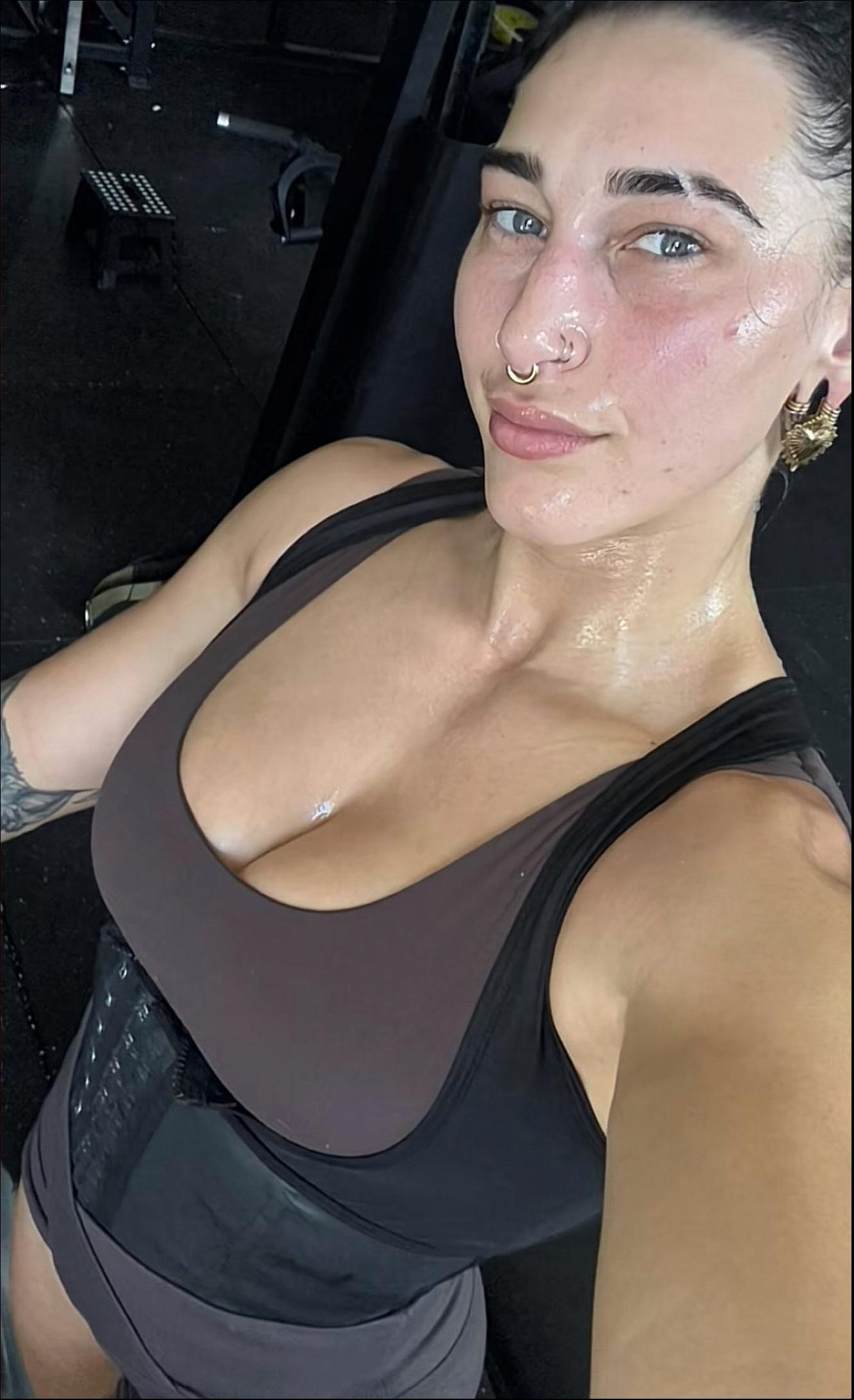 a woman is standing in a bathroom with a black towel