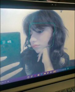 a woman is looking at a tv screen