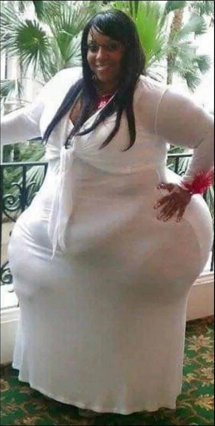 a woman in a white dress is holding a white object