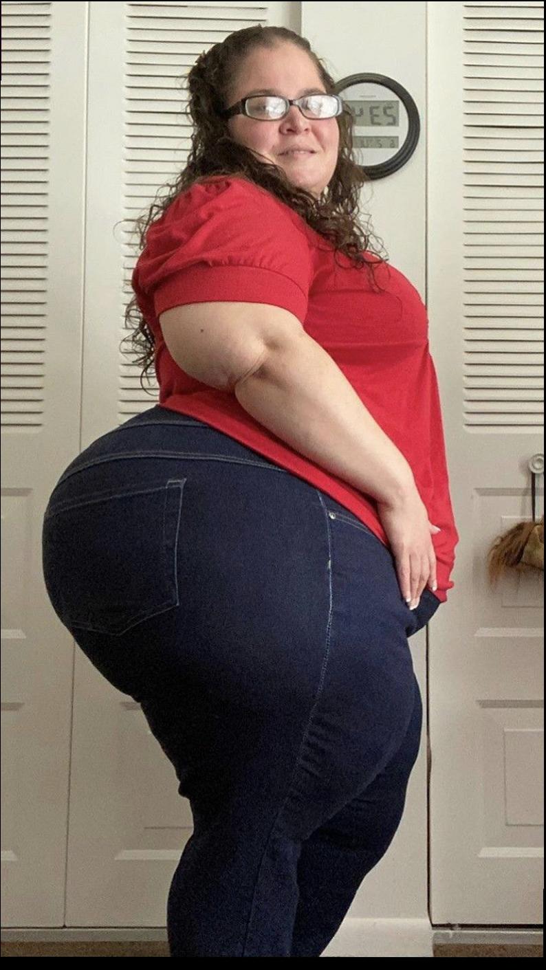 a woman is posing for a picture with a red shirt