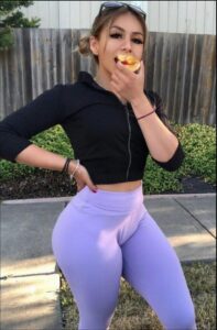 a woman is eating a piece of food