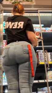 a woman is standing in a store with a sign