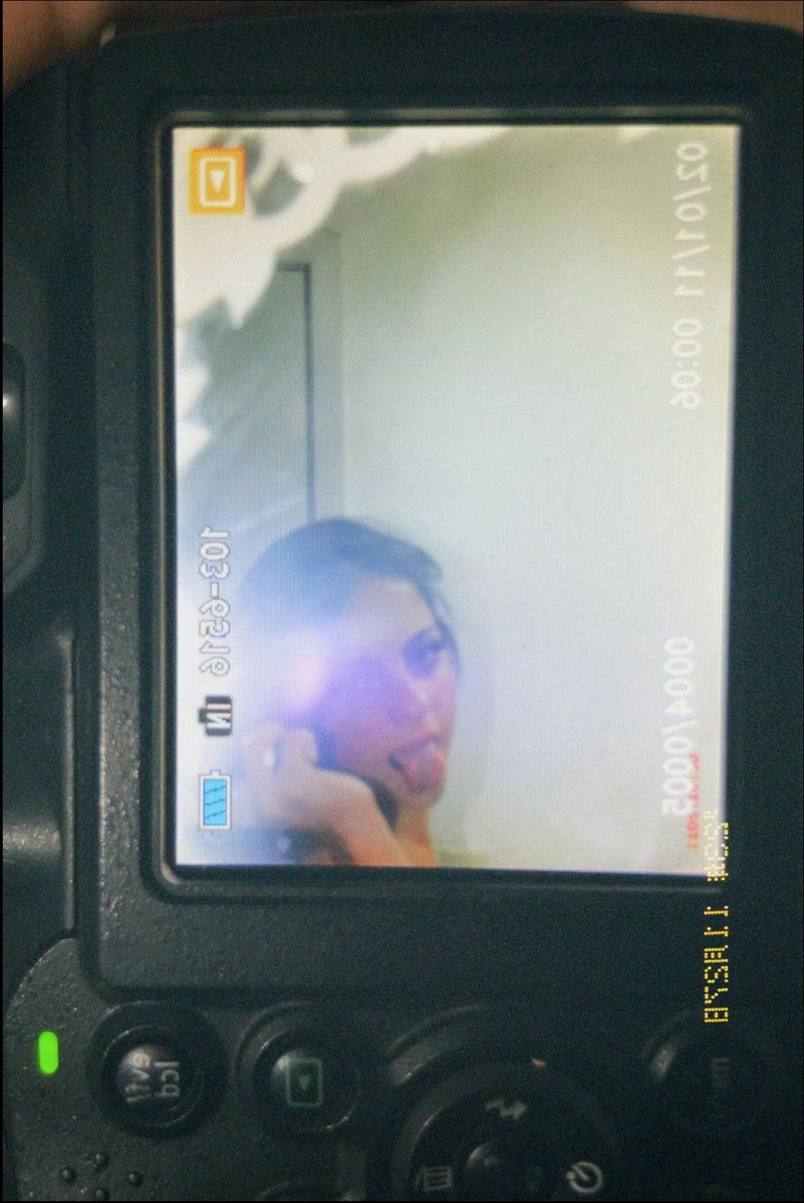 a woman is looking at a tv screen