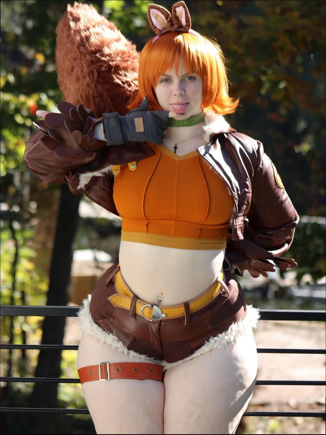 a woman dressed in a costume and holding a stuffed animal