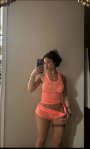 a woman is taking a picture of herself in a mirror