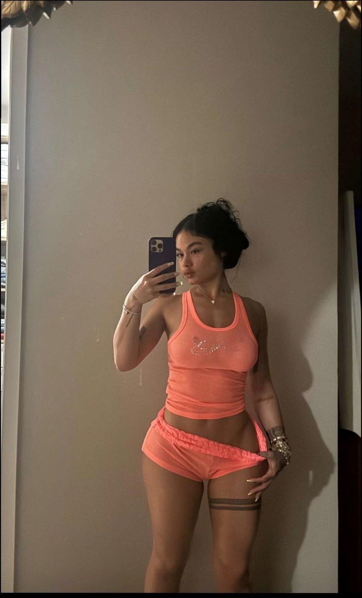 a woman is taking a picture of herself in a mirror