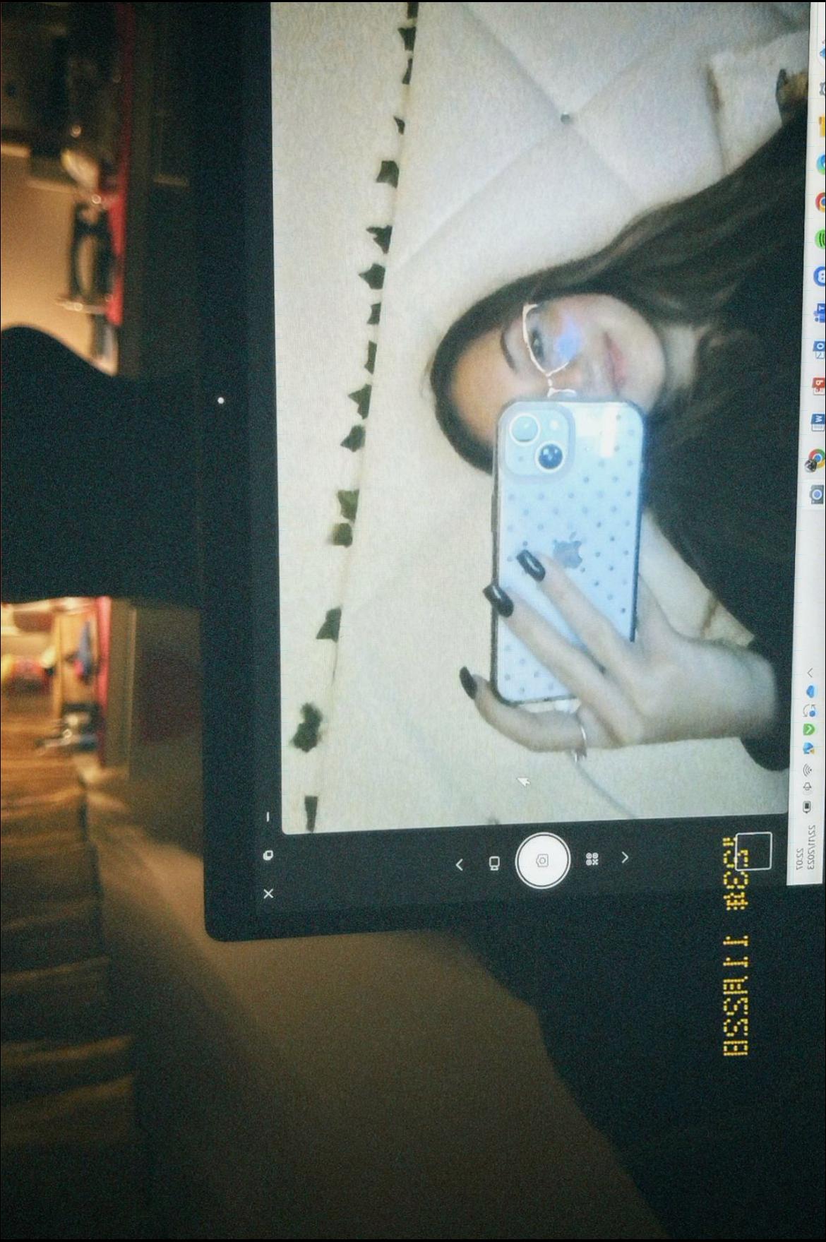 a woman holding a laptop on a wall