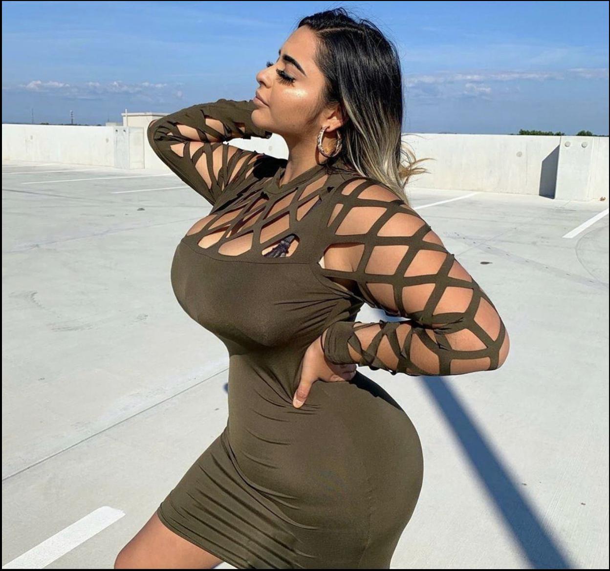 a woman in a black dress is on a ledge