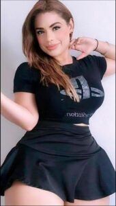 a woman in a black dress is holding a white object