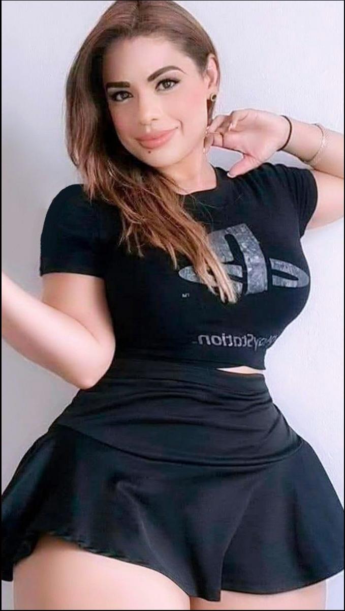 a woman in a black dress is holding a white object