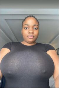 a woman is smiling and holding a camera